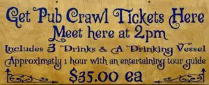 Pub crawl tickets sign with event details.