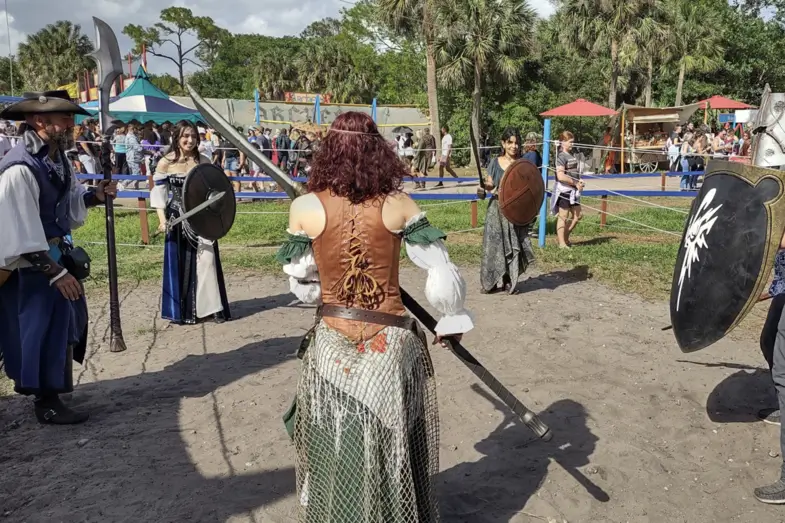 Renaissance fair reenactors in period costumes.